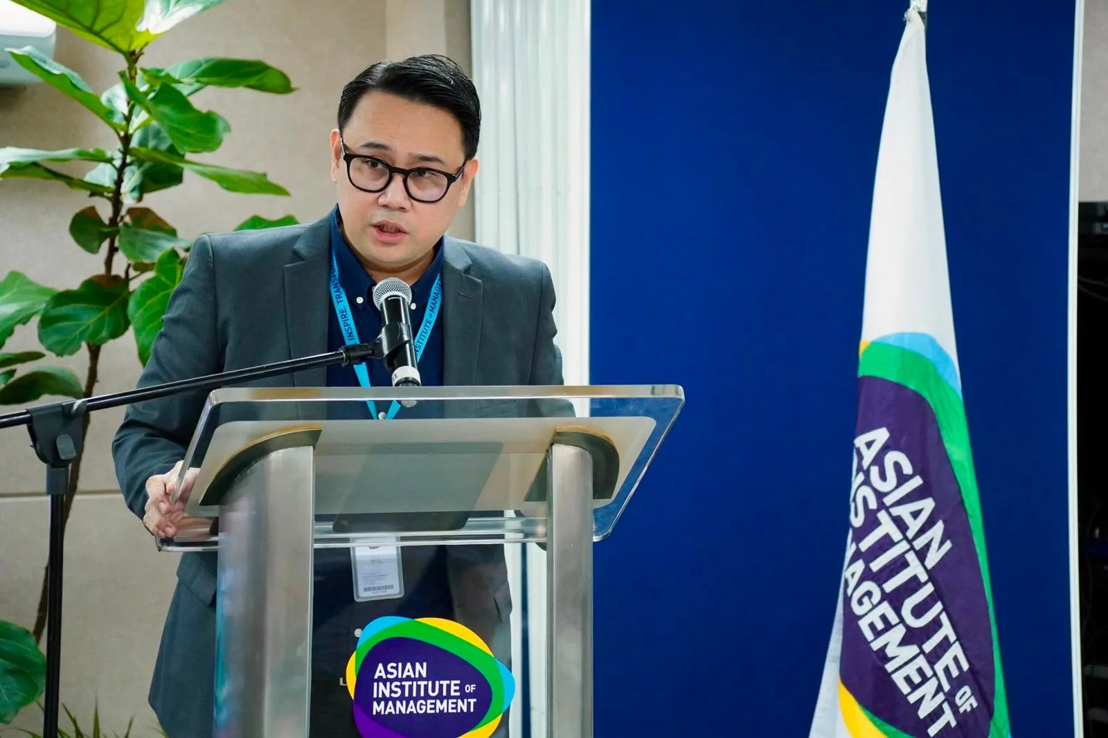 Gil Orense presents to participants the event at the Asian Institute of Management (AIM), speaking on disaster management, AI, and operational intelligence.