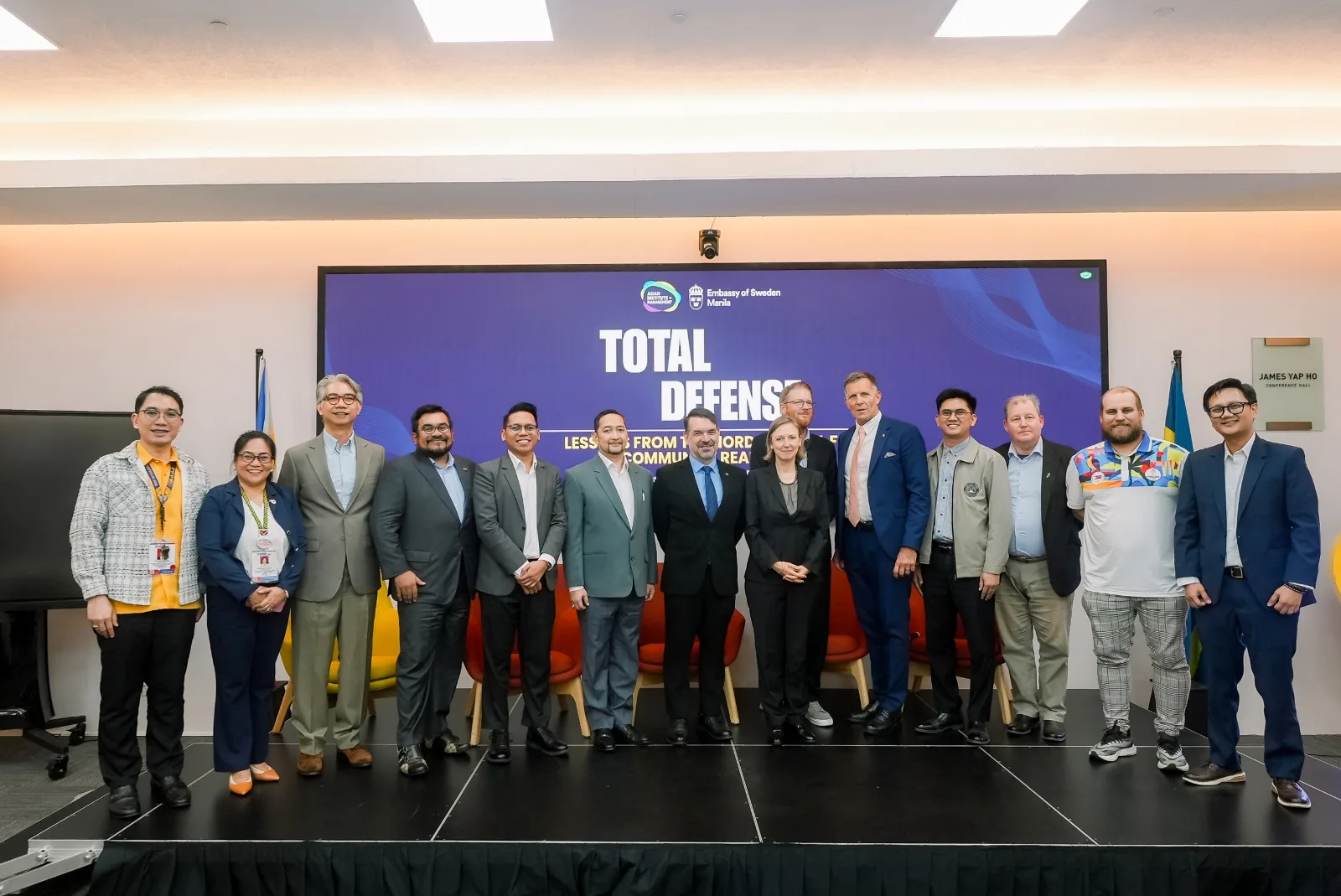 Group photo of speakers, panelists, and participants at the Total Defense forum at the Asian Institute of Management.