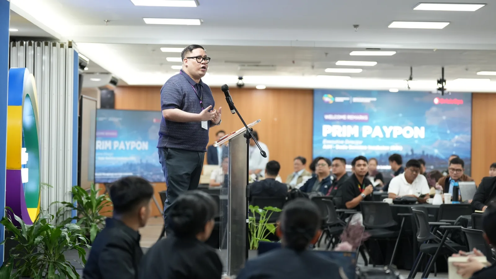 Prim Paypon, Executive Director of AIM-DBI, delivers the opening remarks to participants during the event.